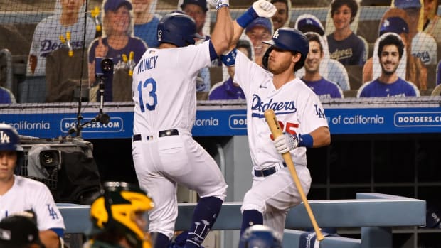 Sep 23, 2020; Los Angeles, California, USA; Los Angeles Dodgers second baseman Max Muncy (13) celebrates hitting a two run homer with teammate Coy Bellinger (35) in the third inning against the Oakland Athletics at Dodger Stadium. Mandatory Credit: Robert Hanashiro-USA TODAY Sports